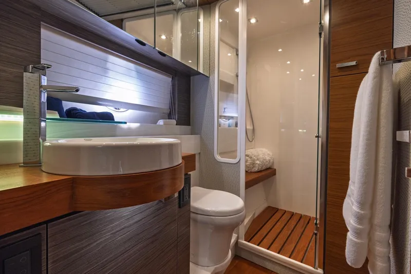 Slide: The Image of Luxurious bathroom in 2020 Tiara Yachts C53 Coupe with modern fixtures and wooden accents. - 76