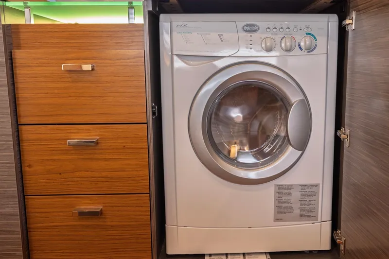 Slide: The Image of Washing machine inside Tiara Yachts C53 Coupe 2020, next to wooden drawers. - 80
