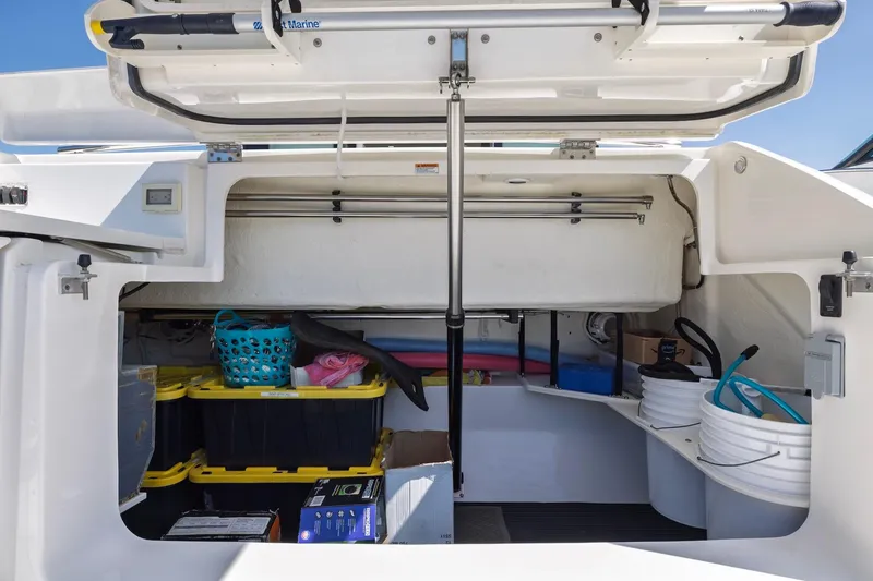 Slide: The Image of Storage compartment of a 2020 Tiara Yachts C53 Coupe, organized with various boating supplies. - 81