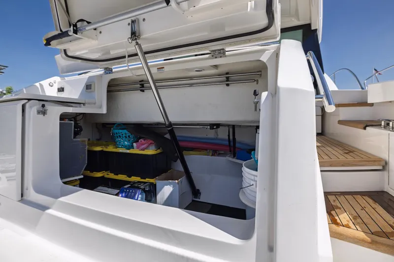 Slide: The Image of Open storage compartment on 2020 Tiara Yachts C53 Coupe, showcasing organized equipment and supplies. - 82