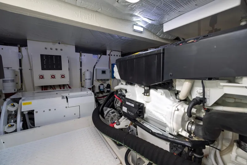 Slide: The Image of Engine room of 2020 Tiara Yachts C53 Coupe, showcasing advanced marine machinery. - 89