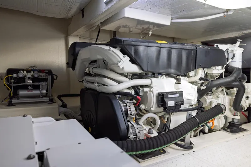Slide: The Image of Engine room of 2020 Tiara Yachts C53 Coupe, showcasing advanced marine machinery. - 94