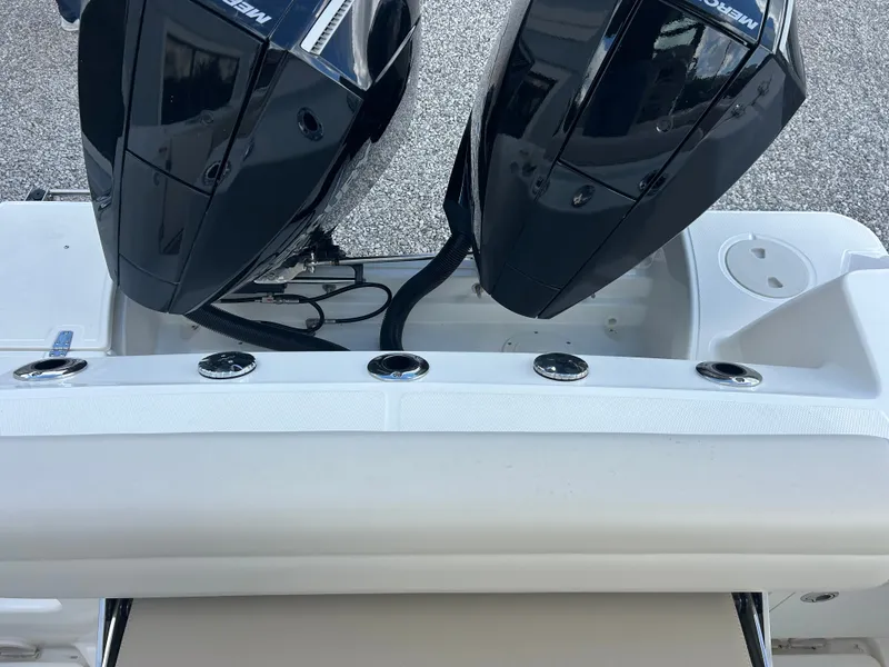 Slide: The Image of Two powerful outboard engines are mounted on the stern of a Boston Whaler 250 Outrage. - 10
