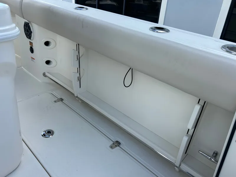Slide: The Image of The image shows the interior of a 2027 Boston Whaler 250 Outrage with storage and holders. - 11