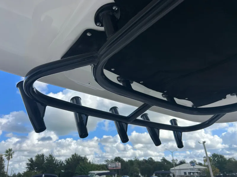 Slide: The Image of A black fishing rod holder is attached to a boat, with blue sky and clouds in the background. - 16