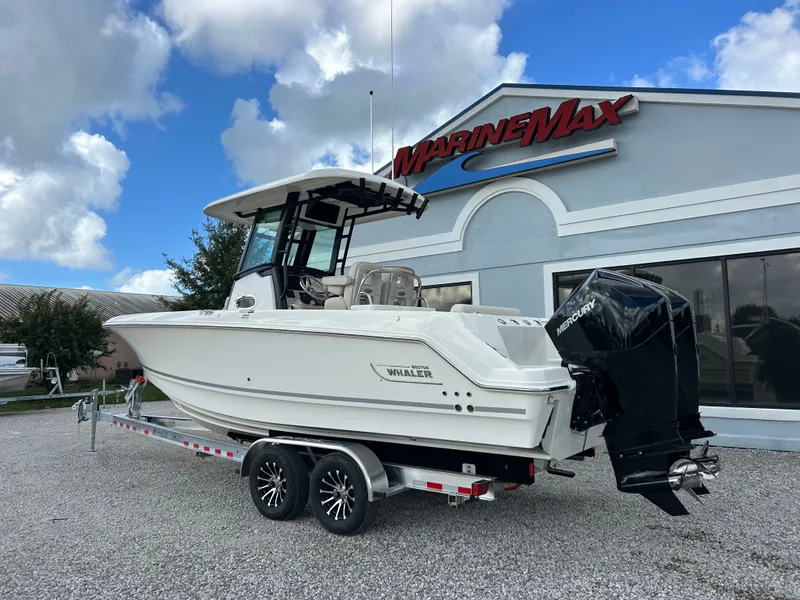 Slide: The Image of A 2027 Boston Whaler 250 Outrage on a trailer in front of a building with a MarineMax logo. - 3