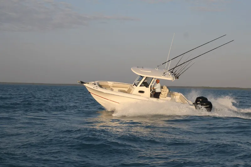 Slide: The Image of A 2027 Boston Whaler 250 Outrage speeds across the water, equipped with fishing rods. - 6