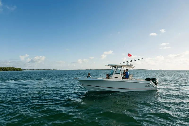 Slide: The Image of A 2027 Boston Whaler 250 Outrage on calm waters with several people on board. - 33