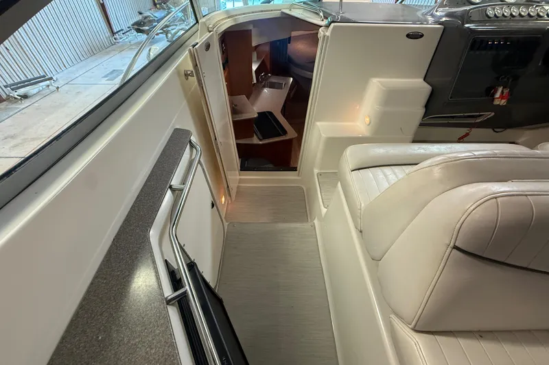 Slide: The Image of 2005 Maxum 3300 SCR boat interior with white seating and cabin entrance. - 10