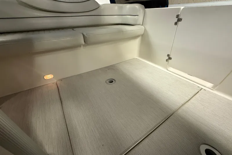 Slide: The Image of 2005 Maxum 3300 SCR boat interior with cushioned seating and carpeted flooring. - 14