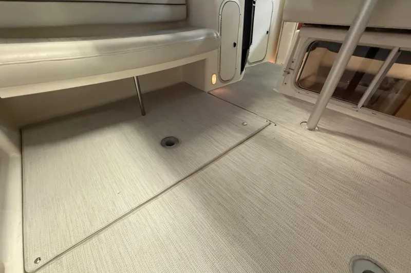Slide: The Image of 2005 Maxum 3300 SCR interior with beige seating and carpeted flooring. - 15