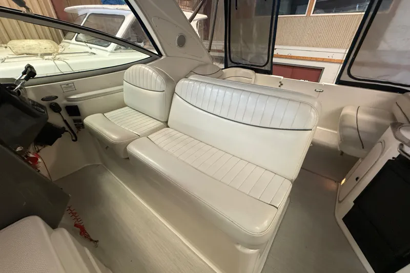 Slide: The Image of 2005 Maxum 3300 SCR boat interior with white leather seating and helm area. - 16