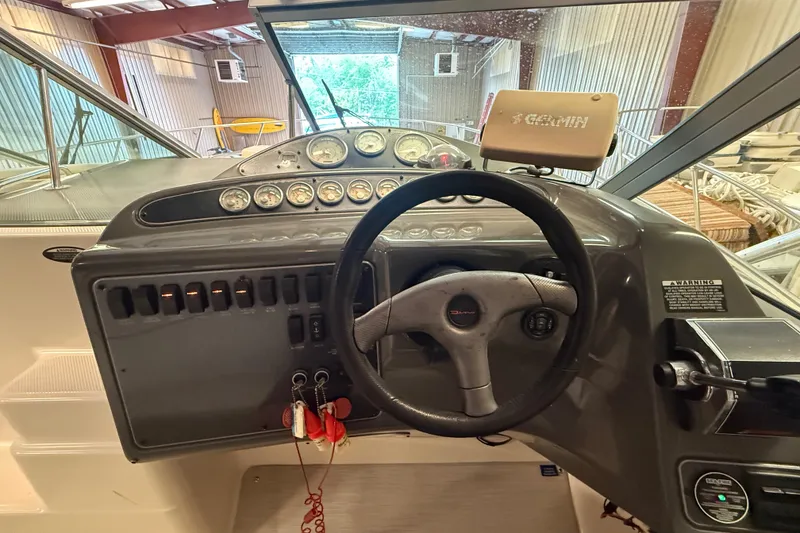 Slide: The Image of 2005 Maxum 3300 SCR boat dashboard with steering wheel and Garmin GPS. - 18