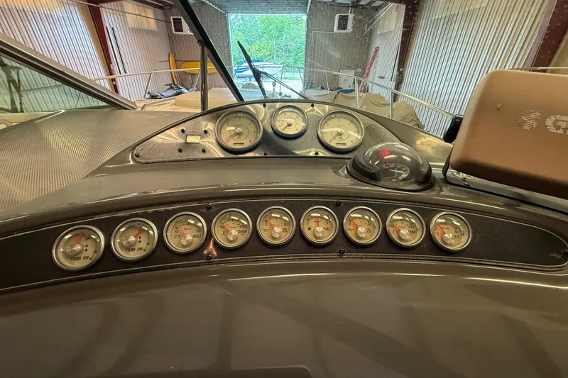 Slide: The Image of Dashboard of a 2005 Maxum 3300 SCR boat with multiple gauges and compass. - 19