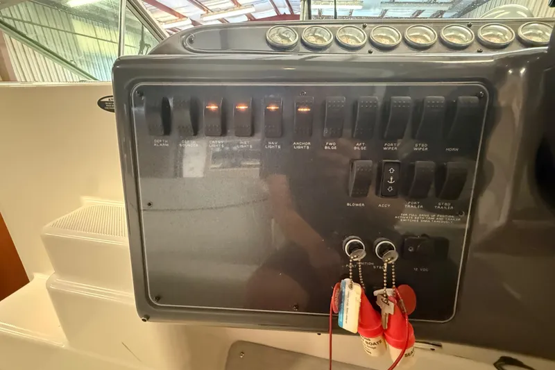 Slide: The Image of Control panel of a 2005 Maxum 3300 SCR boat with switches and keys. - 22