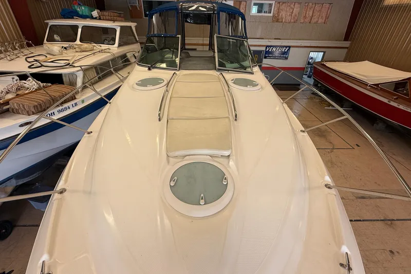Slide: The Image of 2005 Maxum 3300 SCR boat in indoor storage, showcasing sleek design and spacious deck. - 28