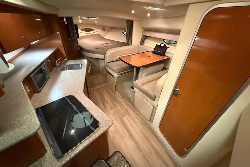 Slide: The Image of Interior of 2005 Maxum 3300 SCR yacht with kitchen, seating, and sleeping area. - 29