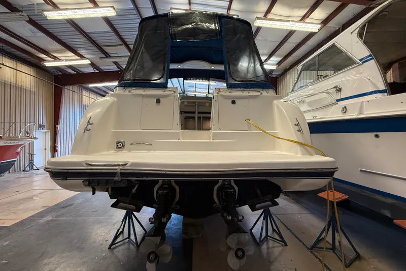 Slide: The Image of 2005 Maxum 3300 SCR boat in storage, rear view, with protective cover. - 3