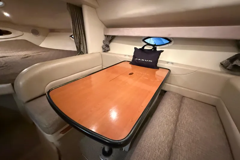 Slide: The Image of 2005 Maxum 3300 SCR cabin interior with dining area and seating. - 31