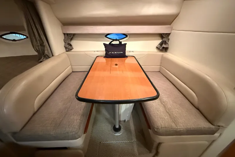 Slide: The Image of Interior of 2005 Maxum 3300 SCR yacht with cozy dining area and wooden table. - 32