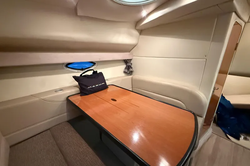Slide: The Image of 2005 Maxum 3300 SCR cabin interior with wooden table and seating area. - 33