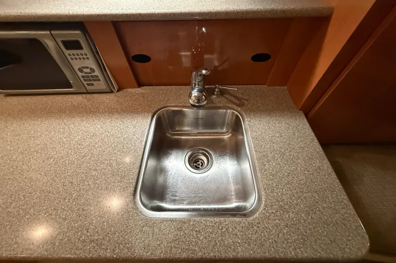 Slide: The Image of Stainless steel sink in 2005 Maxum 3300 SCR boat kitchen with microwave. - 35