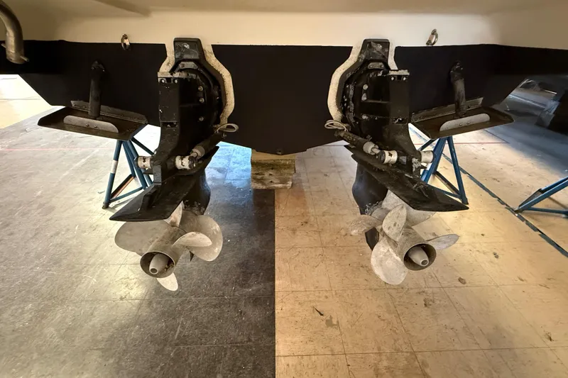 Slide: The Image of 2005 Maxum 3300 SCR boat propellers and stern drives in a workshop setting. - 4
