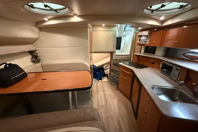 Slide: The Image of Interior of 2005 Maxum 3300 SCR yacht with kitchenette and seating area. - 43