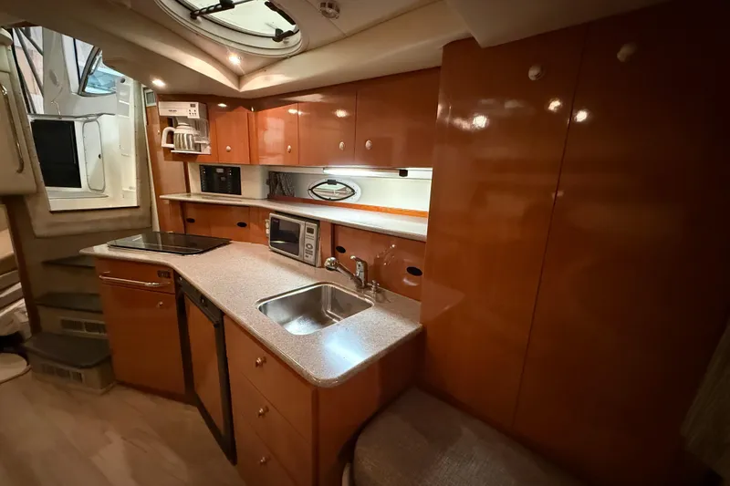 Slide: The Image of 2005 Maxum 3300 SCR yacht interior kitchen with wooden cabinets and modern appliances. - 44