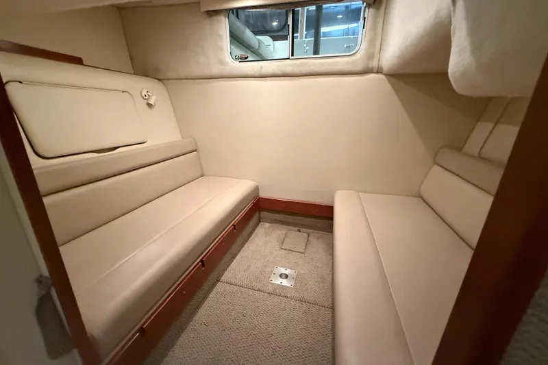 Slide: The Image of 2005 Maxum 3300 SCR cabin interior with beige seating and window. - 45