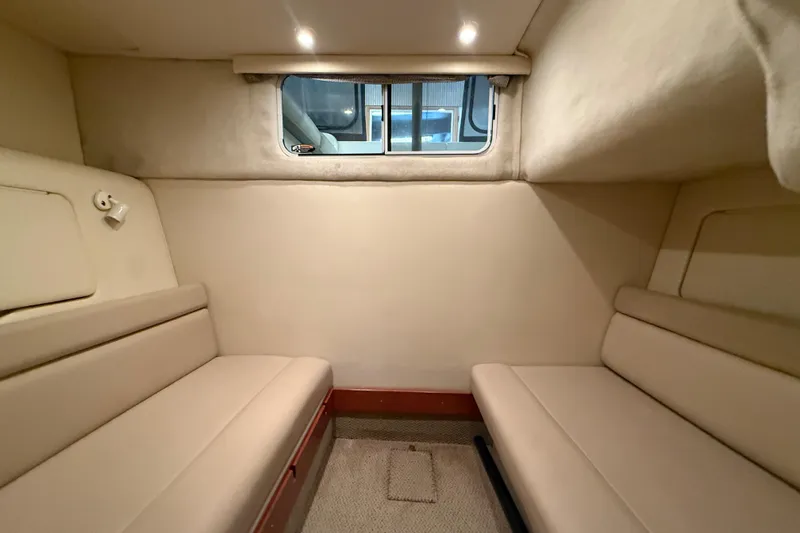 Slide: The Image of Interior cabin of 2005 Maxum 3300 SCR boat with beige seating and window. - 46