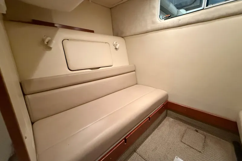 Slide: The Image of Interior cabin of 2005 Maxum 3300 SCR boat with beige seating and window. - 47