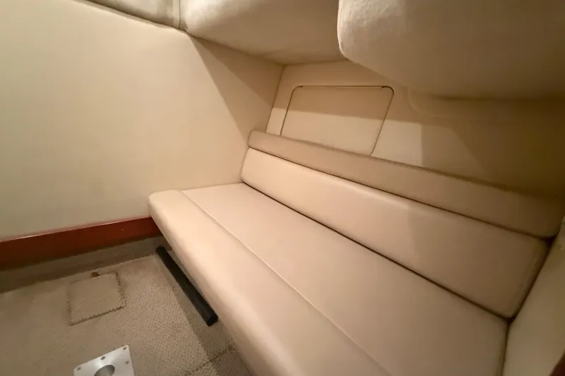Slide: The Image of Interior cabin of 2005 Maxum 3300 SCR boat with beige seating. - 48