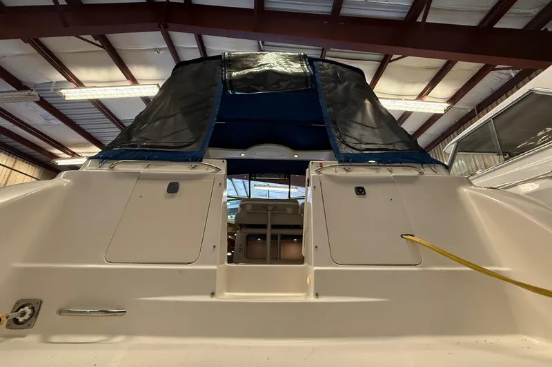 Slide: The Image of 2005 Maxum 3300 SCR boat in storage, rear view with covered cockpit. - 5
