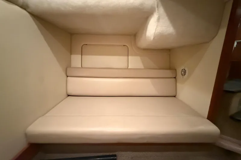 Slide: The Image of Interior cabin seating of 2005 Maxum 3300 SCR boat, featuring beige upholstery. - 50