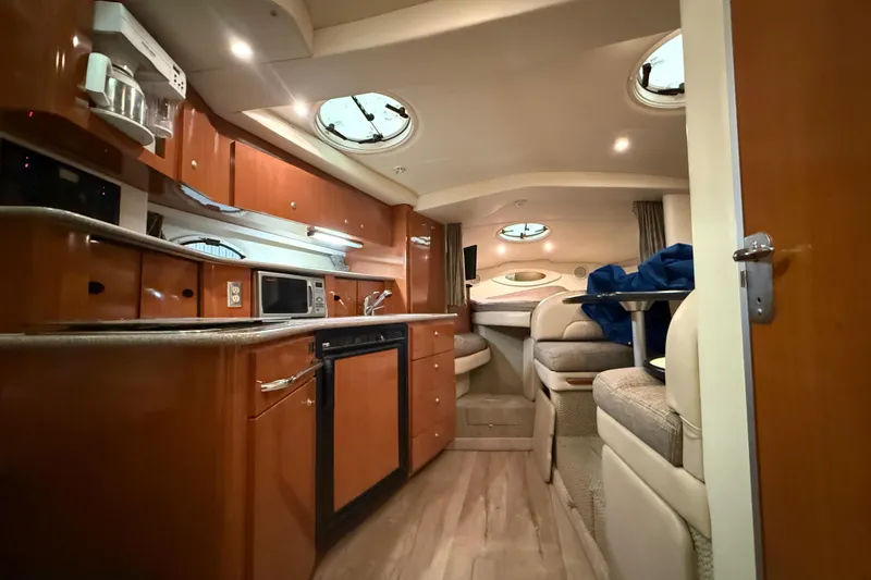 Slide: The Image of Luxurious interior of 2005 Maxum 3300 SCR yacht with kitchen and seating area. - 51