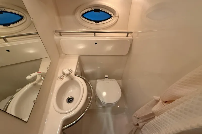 Slide: The Image of Compact bathroom in 2005 Maxum 3300 SCR yacht with sink, toilet, and porthole. - 52