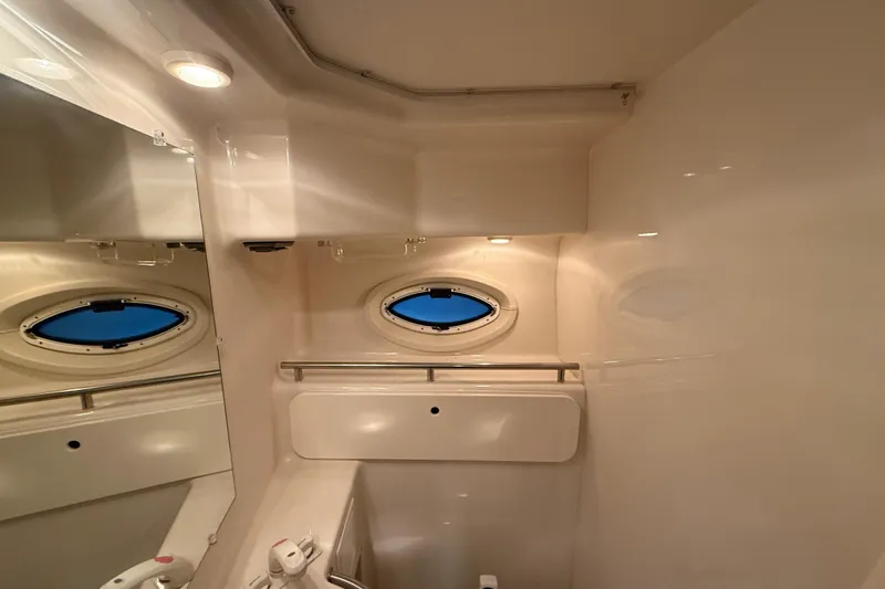 Slide: The Image of Interior of 2005 Maxum 3300 SCR boat bathroom with oval window and mirror. - 53