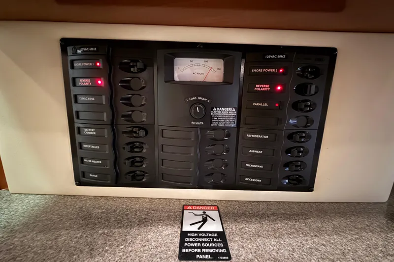 Slide: The Image of Electrical control panel on a 2005 Maxum 3300 SCR boat with warning label. - 55