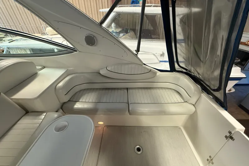 Slide: The Image of 2005 Maxum 3300 SCR boat interior with white seating and table. - 7