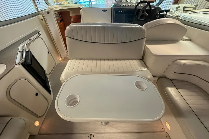 Slide: The Image of Interior of 2005 Maxum 3300 SCR boat with seating and table setup. - 9