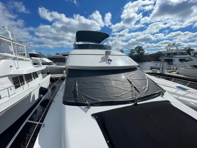 Slide: The Image of 1998 Carver 530 Voyager Pilothouse yacht docked under a partly cloudy sky. - 10