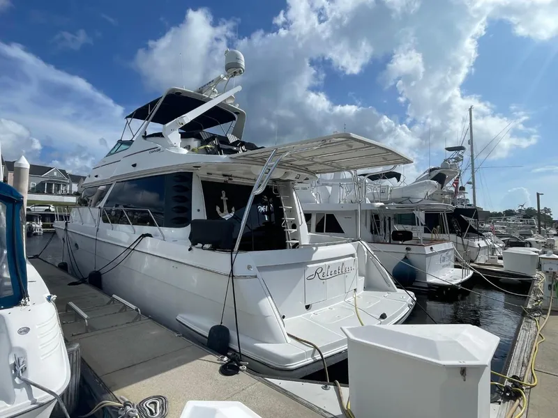 Slide: The Image of 1998 Carver 530 Voyager Pilothouse yacht docked at marina under blue sky. - 2