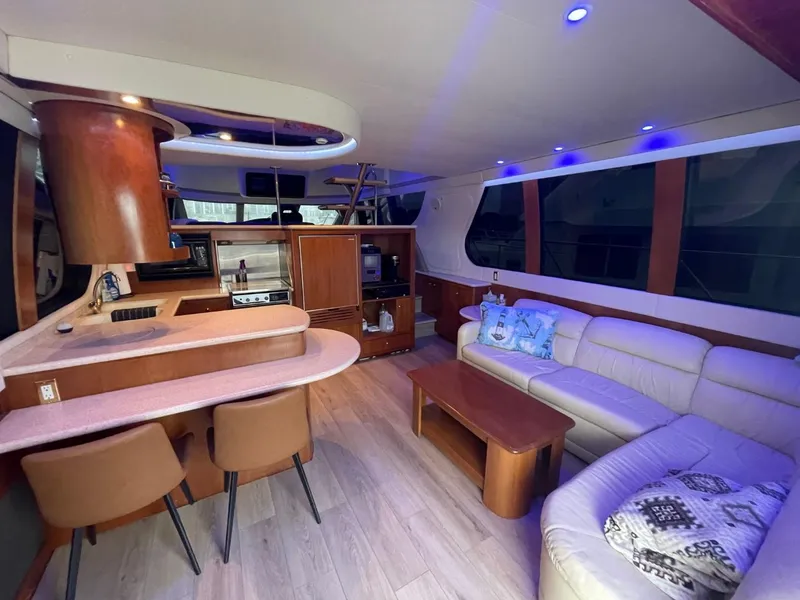Slide: The Image of Luxurious interior of 1998 Carver 530 Voyager Pilothouse with modern seating and kitchen area. - 34
