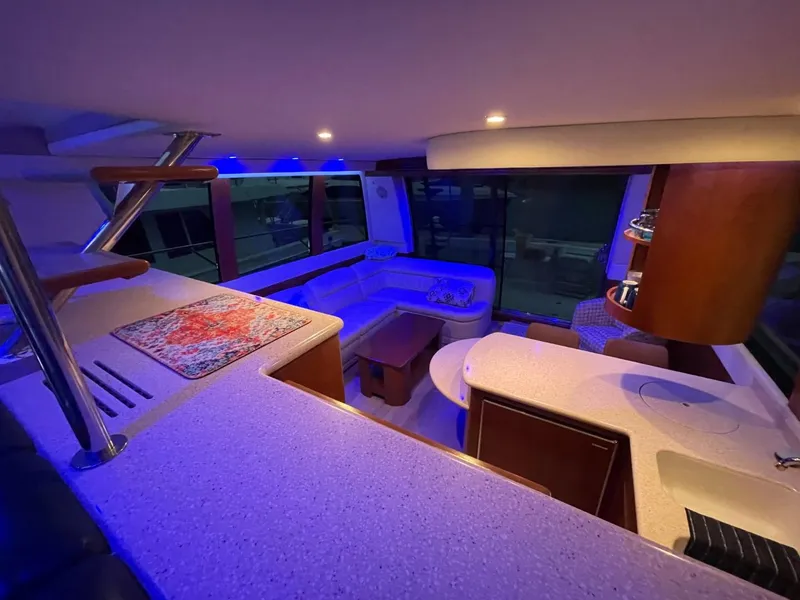 Slide: The Image of Luxurious interior of 1998 Carver 530 Voyager Pilothouse with modern lighting and seating. - 43