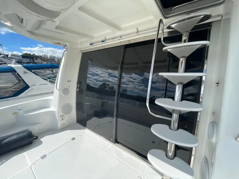 Slide: The Image of 1998 Carver 530 Voyager Pilothouse yacht interior with spiral staircase and sliding glass doors. - 8