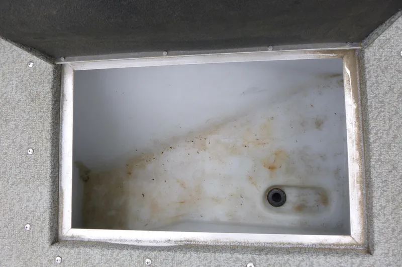 Slide: The Image of Open storage compartment in a 2012 Lund 1775 Impact boat, showing interior details. - 11