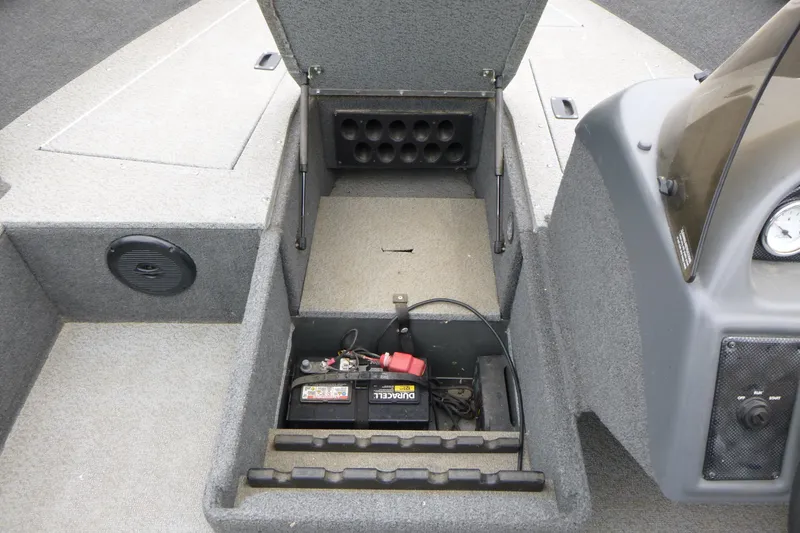 Slide: The Image of 2012 Lund 1775 Impact boat battery compartment with storage and speaker. - 12