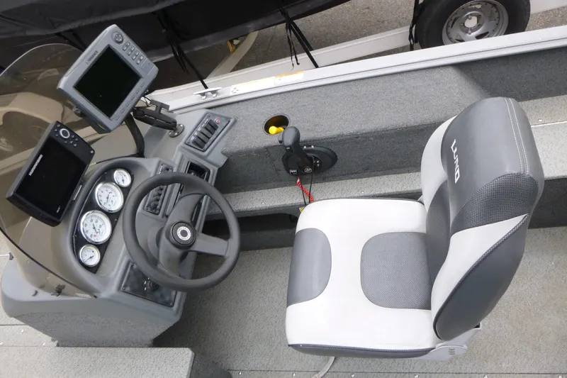 Slide: The Image of 2012 Lund 1775 Impact boat interior with steering wheel, gauges, and seat. - 13