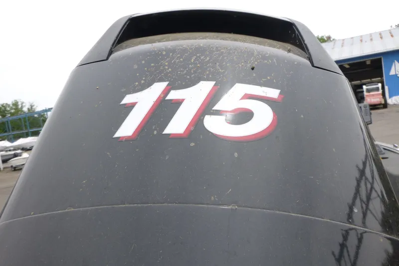 Slide: The Image of Outboard motor with "115" label on a 2012 Lund 1775 Impact boat. - 16